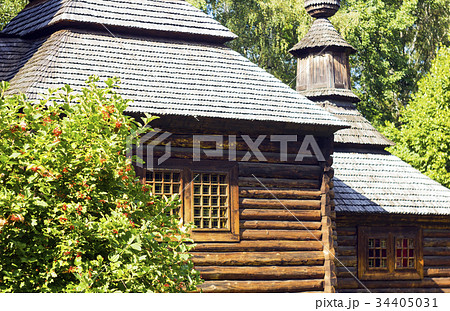 Old nice wooden house near bush viburnum 34405031