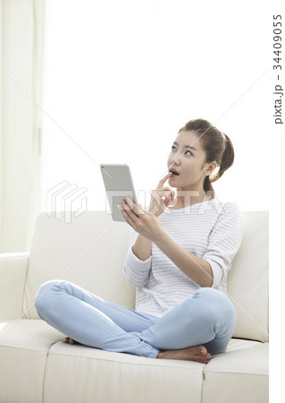 アイパッドミニ 若い女性 表情 34409055