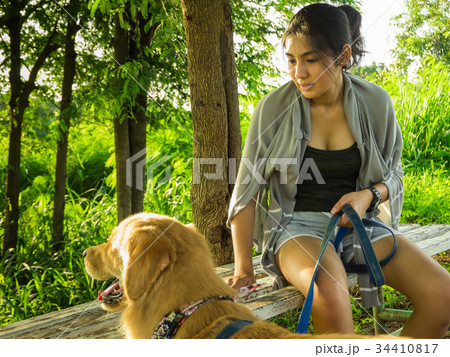 Golden retriever and Asian woman Golden retriever and Asian woman 34410817