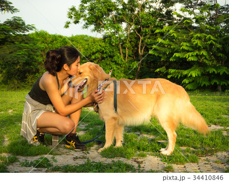 Golden retriever and Asian woman Golden retriever and Asian woman 34410846