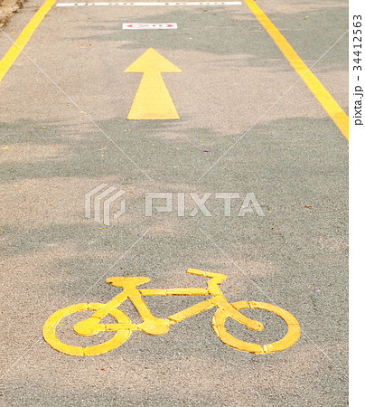 yellow arrows and bicycle sign path on the road yellow arrows and bicycle sign path on the road 34412563