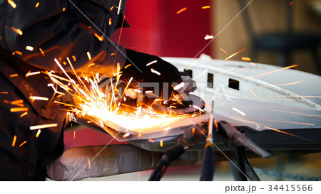 worker grinding metal construction  34415566
