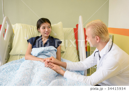 caucasian doctor taking care of suffering patient 34415934
