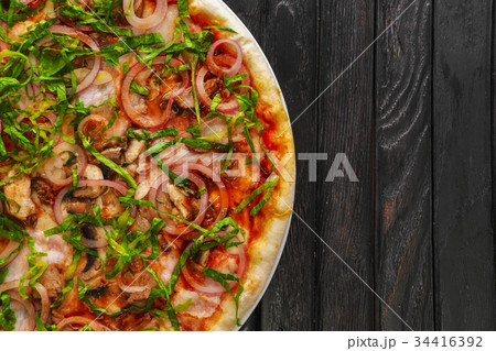 Top view of tasty pizza with sausage and shallot Top view of tasty pizza with sausage and shallot 34416392