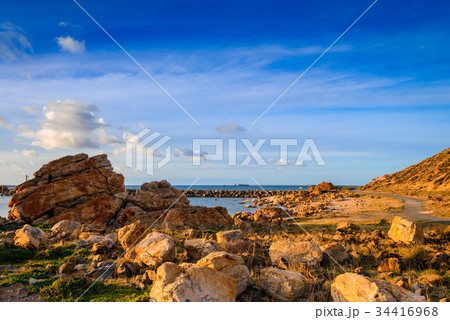Pathway along the sea at sunset 34416968