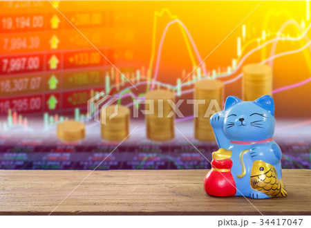 lucky cat bank on wooden table with blur stock. 34417047