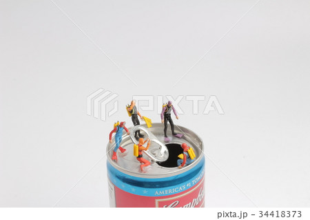 small diver stands on an open aluminum can small diver stands on an open aluminum can 34418373