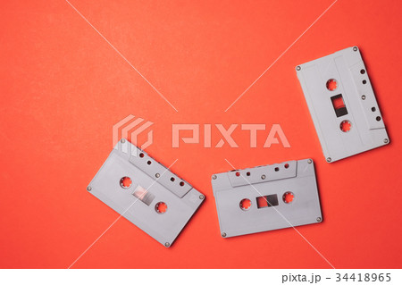Audio cassette tapes on a orange background. Audio cassette tapes on a orange background. 34418965