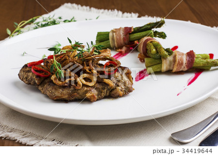 Meat steak under fried onions and peppers Meat steak under fried onions and peppers 34419644