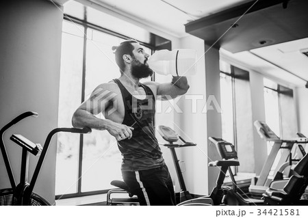 guy relaxing after workout and hold or drink water 34421581