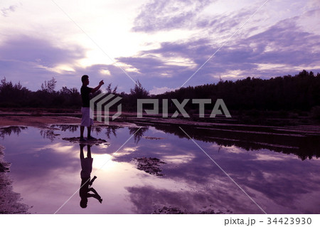 Mirror of man, purple sky reflection to the water 34423930
