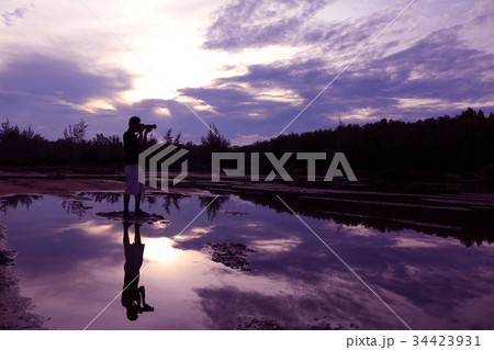 Mirror of man, purple sky reflection to the water 34423931