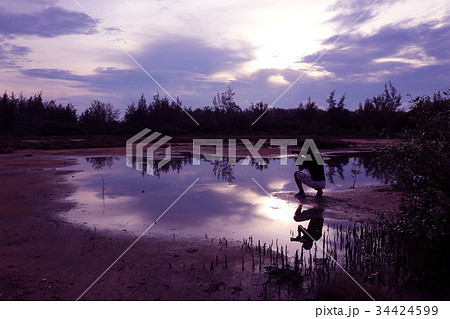Mirror of man, purple sky reflection to the water 34424599