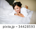 Joyful bride in the morning on the bed in bathrobe 34428593