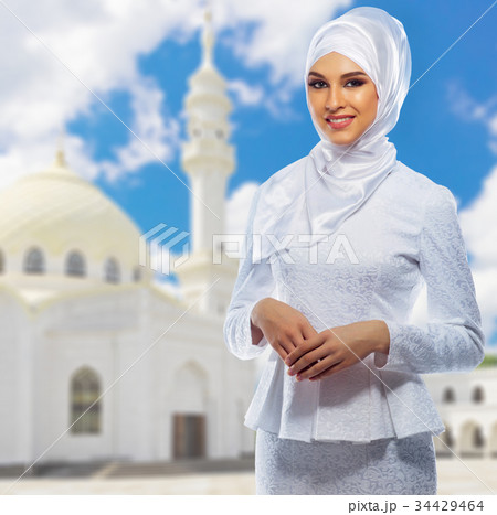 Muslim woman with white mosque 34429464