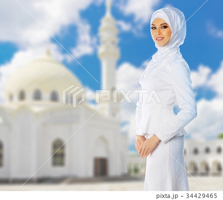 Muslim woman with white mosque Muslim woman with white mosque 34429465