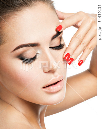 woman with red nails and brown makeup. woman with red nails and brown makeup. 34430135