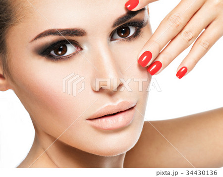 woman with red nails and brown makeup. woman with red nails and brown makeup. 34430136