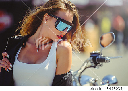 Casual beautiful woman sits on a big tourist motor 34430354
