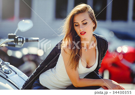 Casual beautiful woman sits on a big tourist motor 34430355