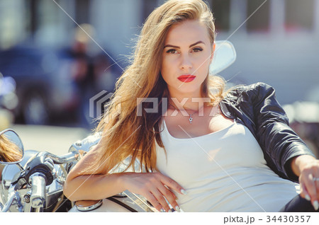 Casual beautiful woman sits on a big tourist motor 34430357