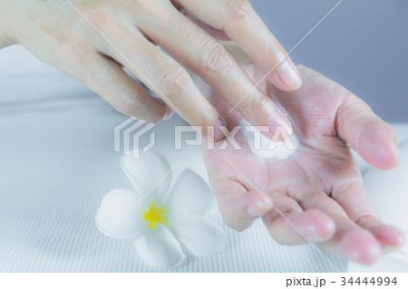 hand of woman apply lotion on skin of hand 34444994