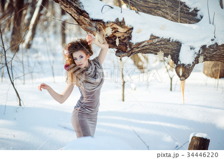 beautiful girl in the winter forest  34446220
