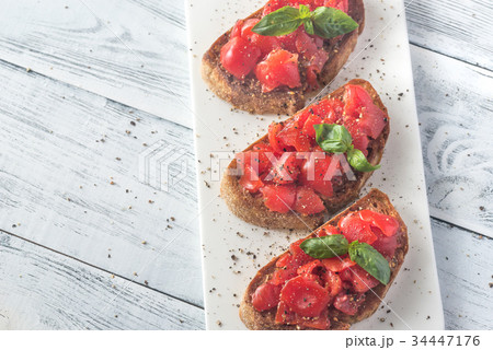 Bruschetta with cherry tomatoes and basil Bruschetta with cherry tomatoes and basil 34447176