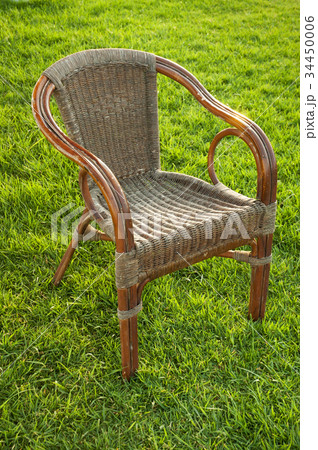 Grass lawn with a wicker chair 34450006