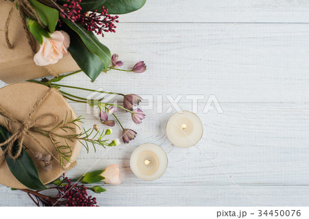 Gifts and lit candles, flower 34450076