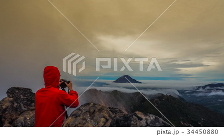 Freedom man standing on top of Mount Sibayak, Indo Freedom man standing on top of Mount Sibayak, Indo 34450880