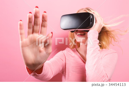 Young woman using virtual reality headset 34454113