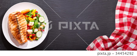 plate of grilled salmon steak with vegetables plate of grilled salmon steak with vegetables 34454292