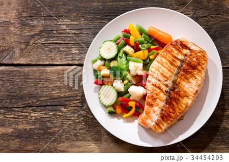 plate of grilled salmon steak with vegetables plate of grilled salmon steak with vegetables 34454293