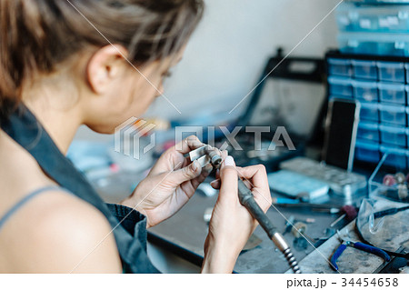 The girl is engaged in jewelry business 34454658