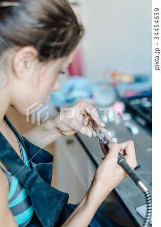 The girl is engaged in jewelry business 34454659