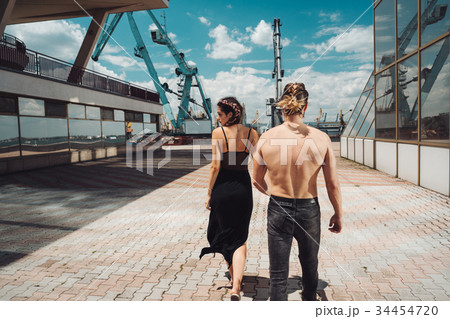 The girl leads the guy by the hand 34454720