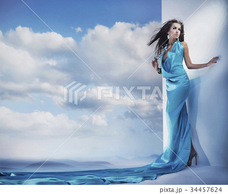 Smart, sensual lady wearing long, turquoise gown 34457624