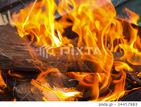brown log is covered with an orange bright flame 34457983