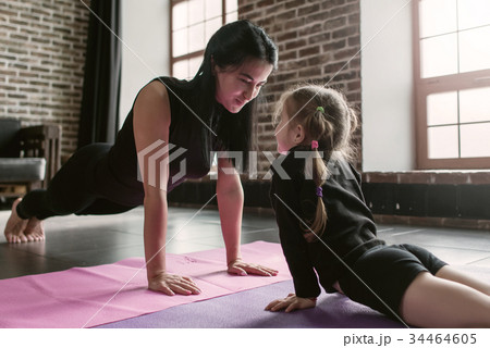 Two sisters of different age wearing black sports Two sisters of different age wearing black sports 34464605