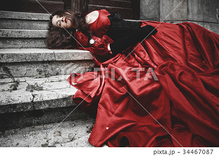 Lying and bleeding woman in a red Victorian dress Lying and bleeding woman in a red Victorian dress 34467087