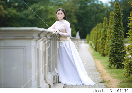 Woman in white Victorian dress in spring park 34467150