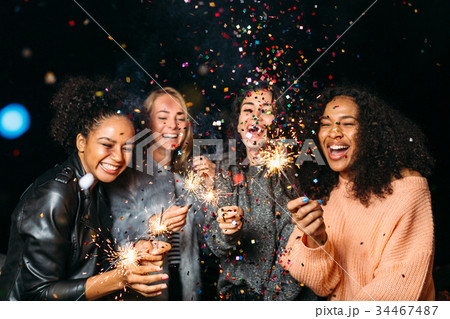 Group of happy women with sparklers at night 34467487