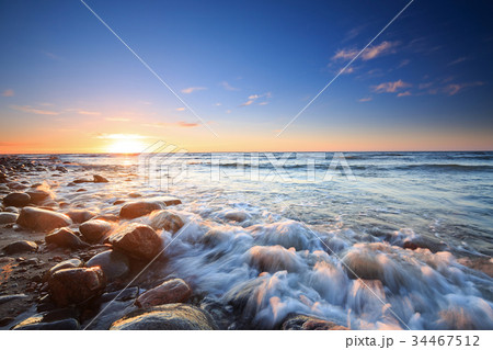 Sunset over the Baltic sea. The pebbly beach Sunset over the Baltic sea. The pebbly beach 34467512