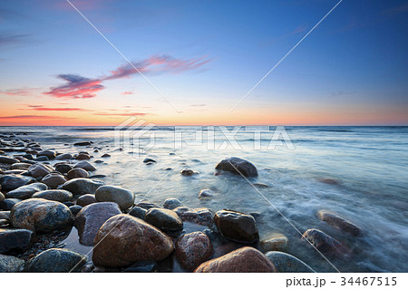 Sunset over the Baltic sea. The pebbly beach  34467515