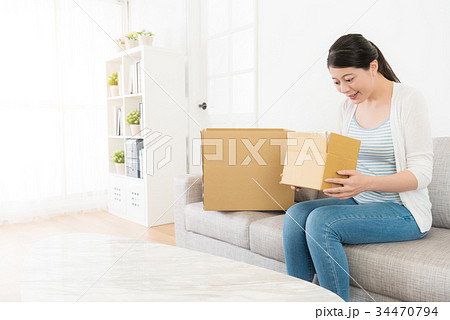 young beautiful lady received delivery package 34470794