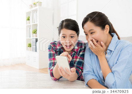 happy female friends using mobile cell phone 34470925