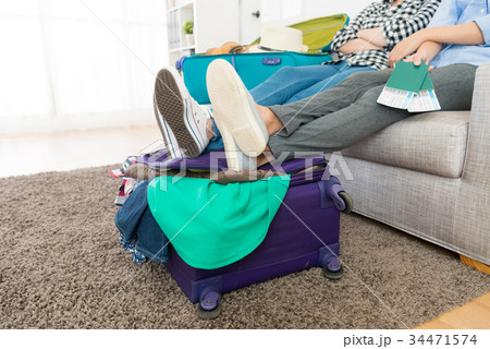 attractive girl friends packing travel luggage 34471574