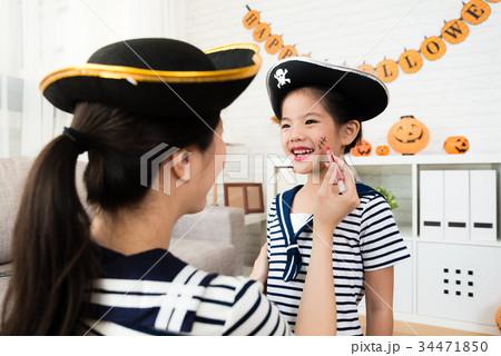 girl and mother play Halloween makeup 34471850