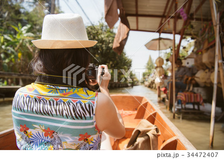 traveler using camera taking picture of vendors traveler using camera taking picture of vendors 34472407